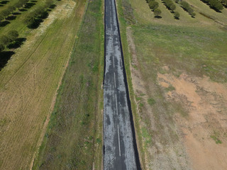 aerial view of village road and harvest fields