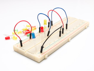 LEDs and cables on prototype table isolated on white background
