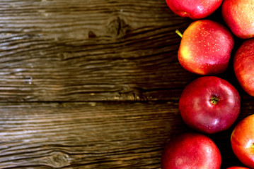 Background of apples whole and cut on wood