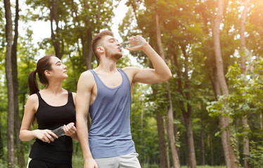Obraz premium Couple runners is having break, drinking water