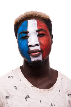Face portrait of afro fan support France national team with painted face isolated on white background