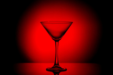 Martini glass in a gloomy blood red light.