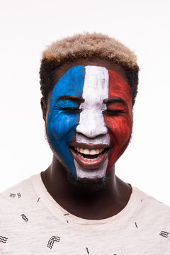 Face portrait of happy afro fan support France national team with painted face isolated on white background