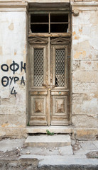 Fototapeta na wymiar Old wooden door and weathered wall