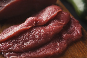 Raw beef filet mignon steaks on wooden board