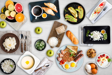 Set of different breakfasts on white  table. Fruits, croissants, apples, honey, coffee, curd, cheese, porridge, bread, english breakfast, avocado, semolina, eggs, sandwiches, granola, muesli, yogurt.