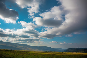 Naklejka na ściany i meble Mountain landscape panorama with dramatic clouds on sky, summer travel background