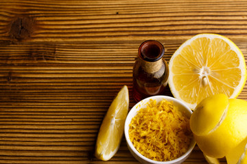 Lemon essential oil on a wooden background