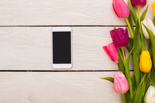 Spring decorations flowers isolated on wooden background smartphone
