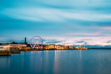 Helsinki, Finland. View Of Embankment With Ferris Wheel In Evening