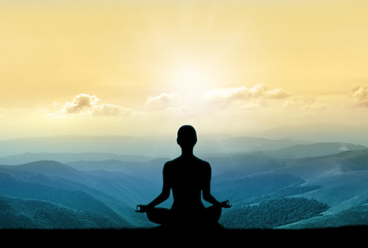 Yoga Silhouette On The Mountain In Sunrays