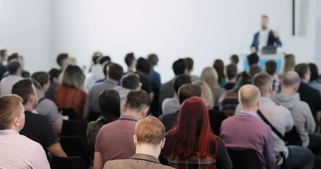 people at a conference. They talk about modern technologies and IT. Problems of digital security, IT people. Listen to the speaker - Powered by Adobe