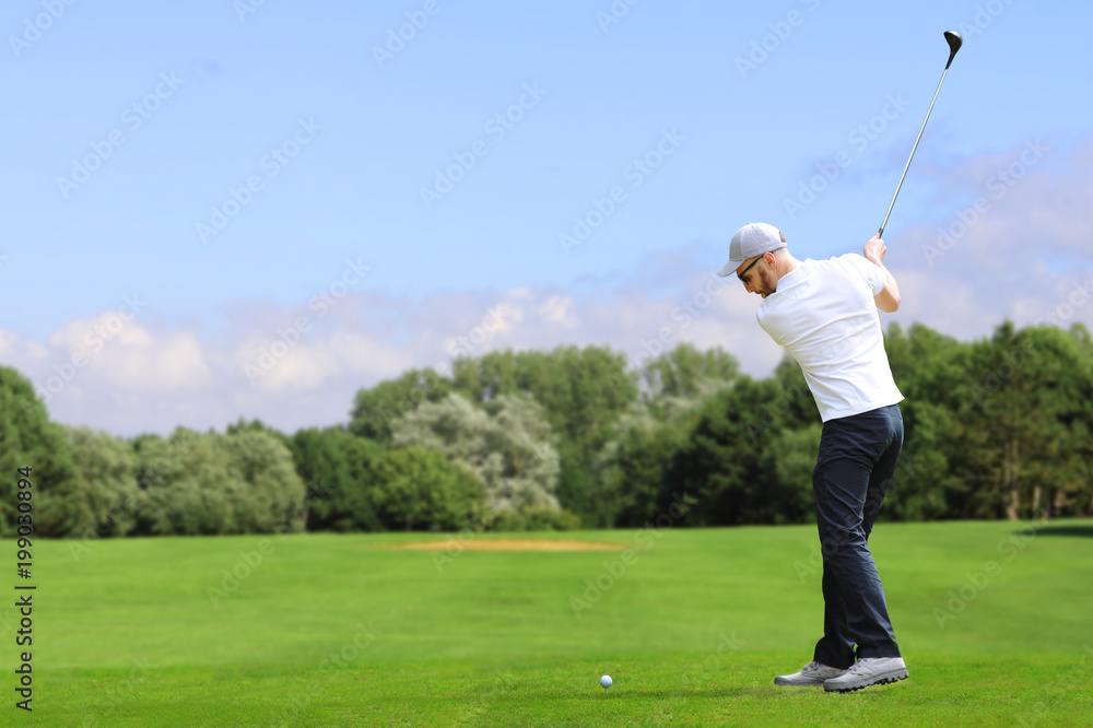 Wall mural Golfer hit a golf ball