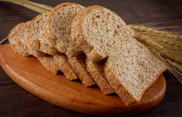 Bread ,toasts on wooden plate and wooden table;food,bakery concept