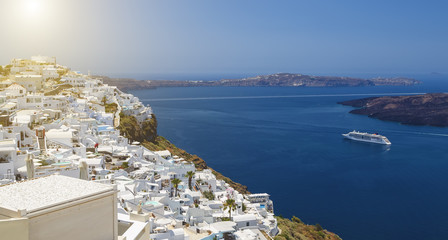 Beautiful panoramic view from touristic Fira town to caldera and volcano and cruise ship at summer sunny day. Santorini(Thira) island.Seascape.