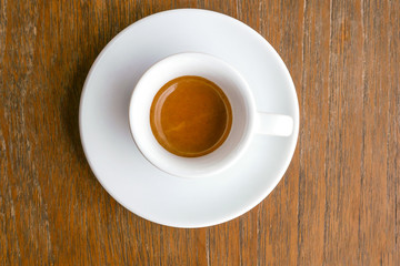 Top view of hot drink espresso coffee cup on wood table background.