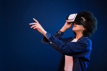 Always create new! Smart good-looking stylish young woman having a great time, while using the virtual vision glasses.