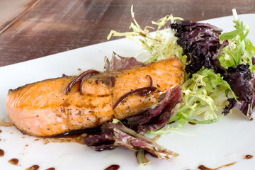 salmon steak with lettuce and sauce