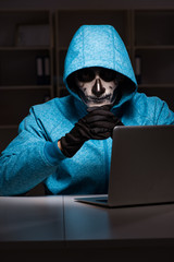 Scary hacker hacking security firewall late in office