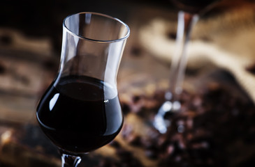 Coffee liqueur, vintage wooden background, selective focus
