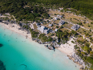 Obraz na płótnie Canvas Ruins of Tulum, Mexico overlooking the Caribbean Sea in the Riviera Maya Aerial View. Tulum beach Quintana Roo Mexico - drone shot. White sand beach and ruins of Tulum.