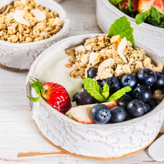 Bowl of natural yogurt with granola and fresh berries