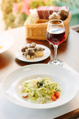 Italian food - fettuccine pasta with pesto sauce.