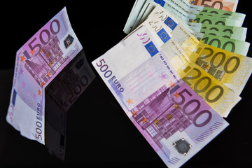Euros reflected of a black glass surface