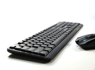 Computer keyboard seen from perspective and computer mouse