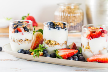 Little Jars with layered dessert from natural yogurt, granola an