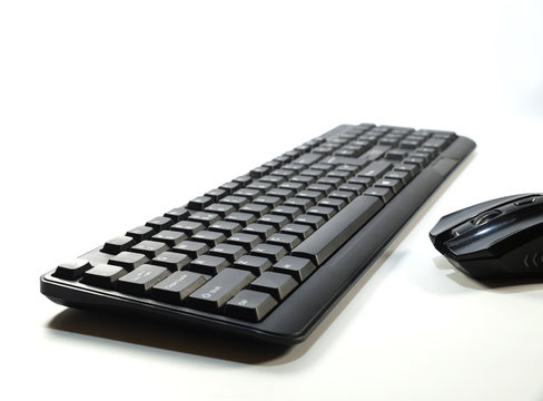 Computer keyboard seen from perspective and computer mouse