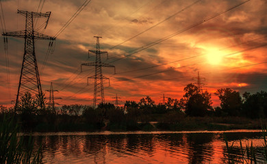  high-voltage  power lines at sunset.