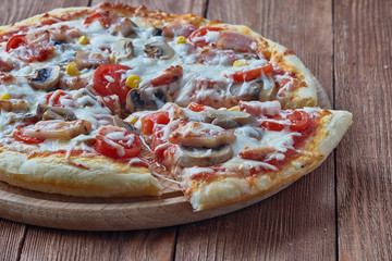 Homemade pizza milano, traditional italian pizza, tomato sauce, mozzarella cheese, bacon, mushrooms,