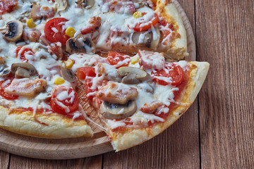 Homemade pizza milano, traditional italian pizza, tomato sauce, mozzarella cheese, bacon, mushrooms,