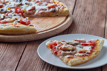 Homemade pizza milano, traditional italian pizza, tomato sauce, mozzarella cheese, bacon, mushrooms,