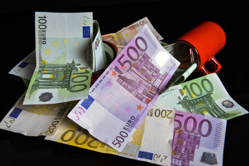 Euro banknotes. Reflection of euros on a black surface. Money saving