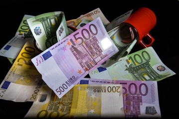 Euro banknotes. Reflection of euros on a black surface. Money saving