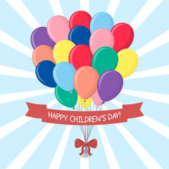 A bouquet of multi-colored balls with a red bow and ribbon with a congratulation, isolated on a sky background. Clouds and sun. Happy Children's Day.