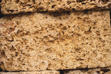 Building blocks from sandstone. Rough texture of bricks made of sand and seashells.