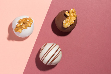 Assorted homemade chocolate truffles. Flat design of candy ball on color background.