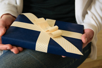 Close Up of woman holding a present box, festive surprise concept