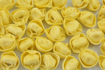 Close up of dry uncooked raw tortellini cheese stuffed pasta