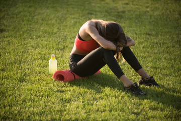 Tired woman in sportswear relax after workout, training