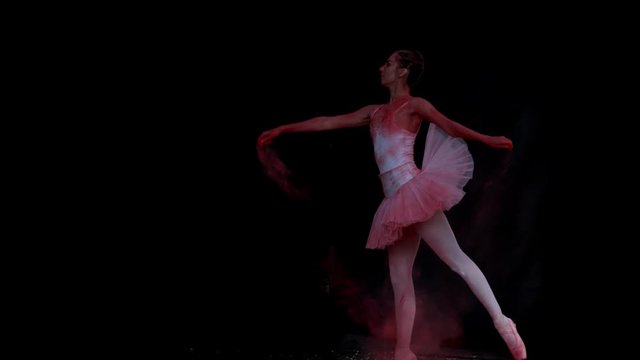 Ballerina performing on black background super slow motion