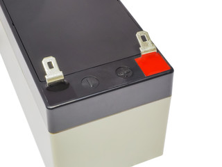 Close-up of DC constant voltage accumulator or battery with terminals for wires connecting. Black,...