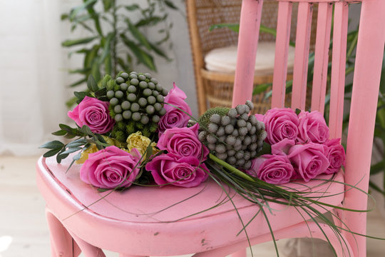 Bunch Of Pink Roses Lying On Pink Shabby Chic Style Wooden Chair Decorated With Decoupage Technique