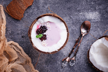 Blackberries smoothie in coconut shell
