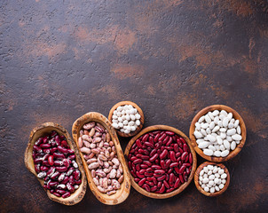 Fototapeta na wymiar Assortment of various beans in wooden bowls