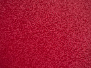 Close-up of the red wavy plastic surface texture for background and wallpaper.