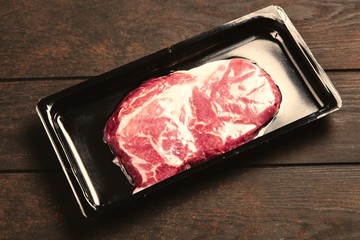 Raw steak in an airtight packaging
